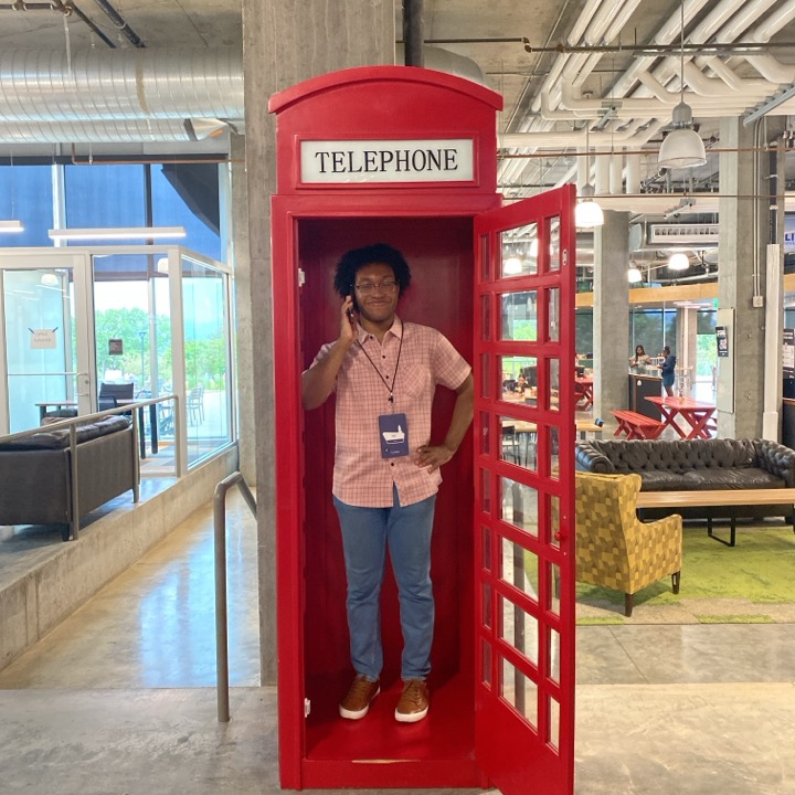 Dimitri helps us complete a scavenger hunt challenge by posing in the red telephone booth.