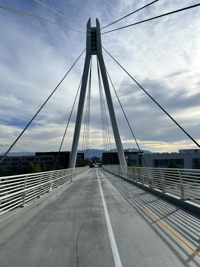 A view from a Salt Lake City bridge that looks out into the horizon with clouds.