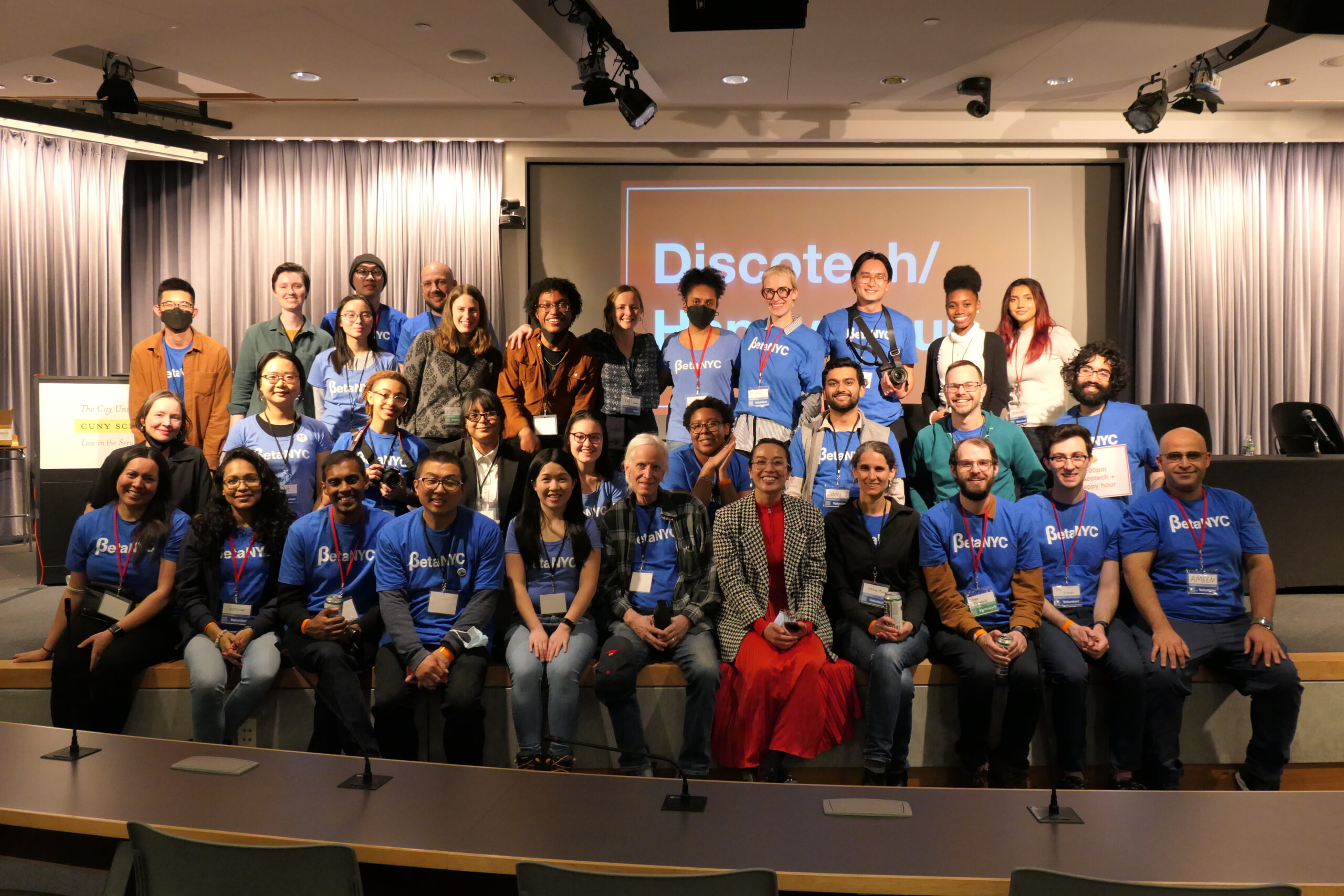 BetaNYC staff and School of Data volunteers pose together onstage at CUNY School of Law.